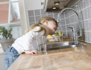Small Girl in the kitchen drinking water | The71Percent | Indiana American Water