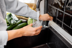 Woman filling up glass of water