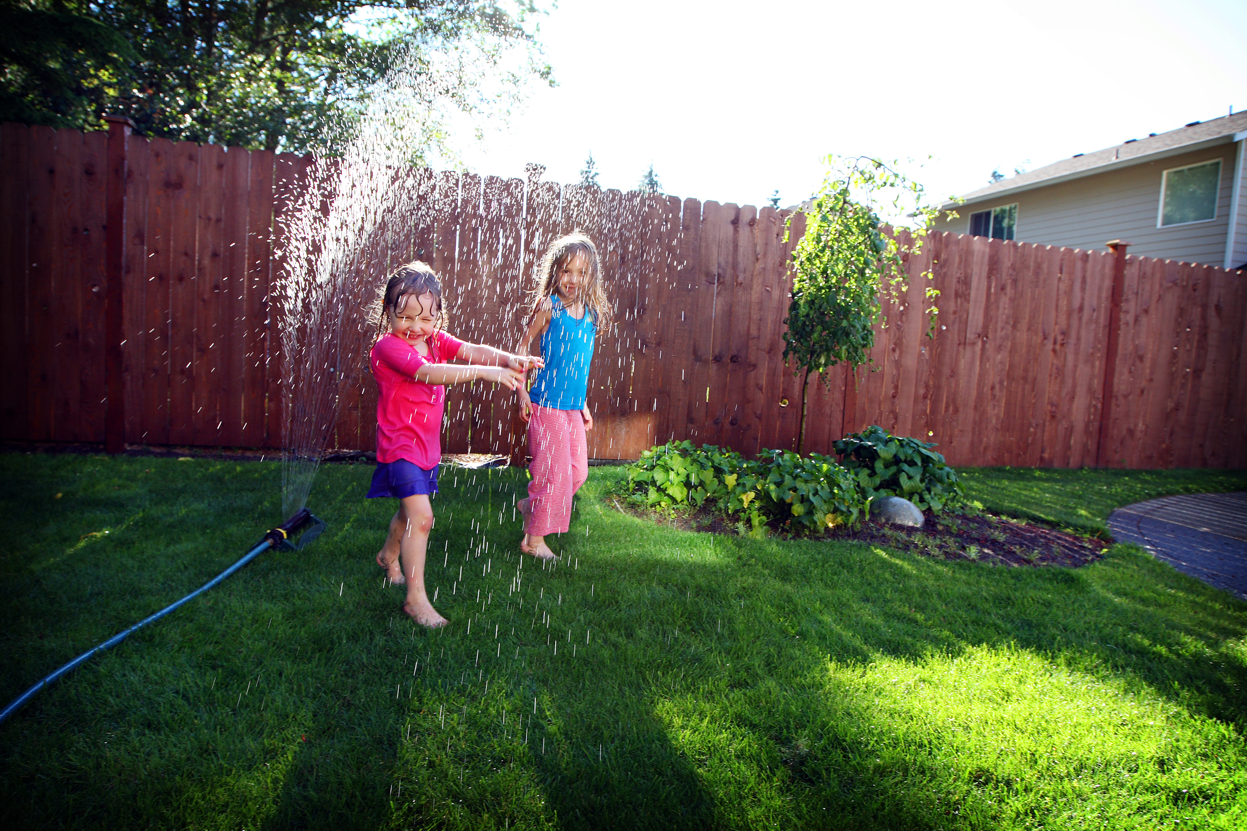 Kids playing in sprinkler